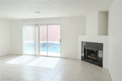 Unfurnished living room featuring light tile patte