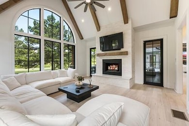Living area with high vaulted ceiling, a ceiling f