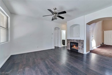 Unfurnished living room with a ceiling fan, wood f
