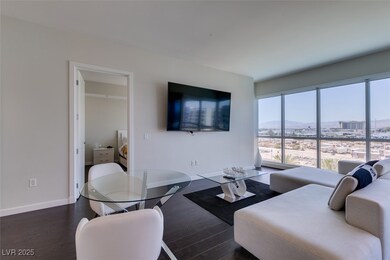 Living area featuring baseboards and wood finished