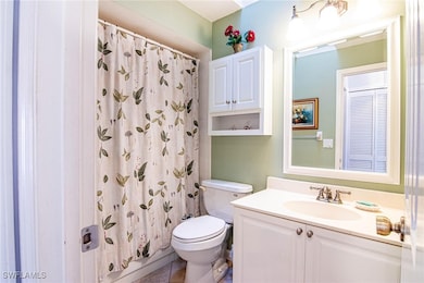 Bathroom with a shower with shower curtain, vanity