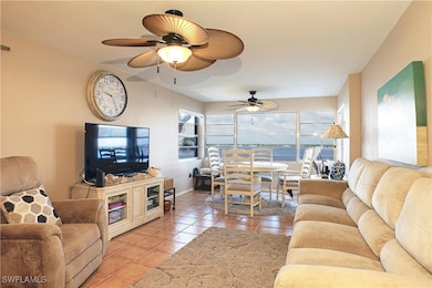 Living room with light tile patterned floors, base