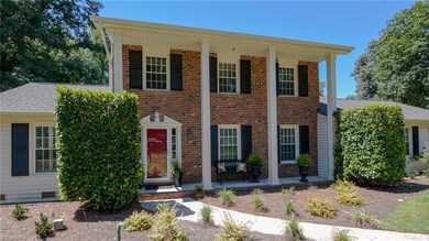 Inviting entrance with beautiful porch for enchanting entrance with beautiful urns planters.
