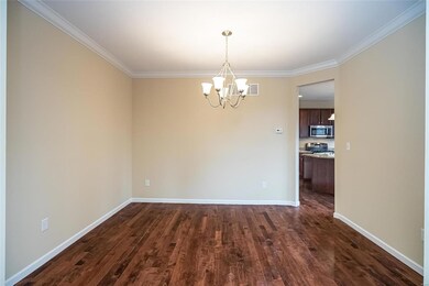 Open to the kitchen and living spaces, the formal 
