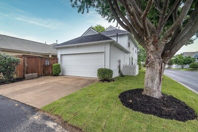 View of home's exterior featuring a garage, concrete driveway, and a shingled roof