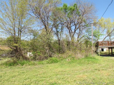 Partially cleared street view of lot