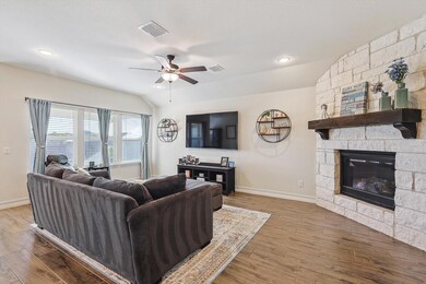 Living room featuring ceiling fan, lofted ceiling,