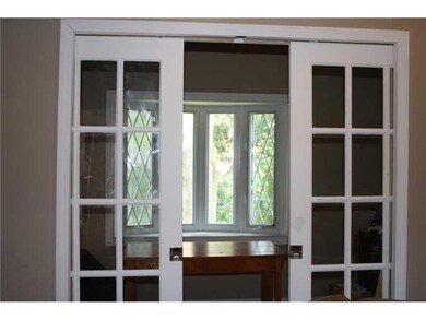 Den. Pocket doors provide privacy for the office l