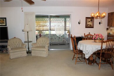 Living and dining area with sliders to Florida roo