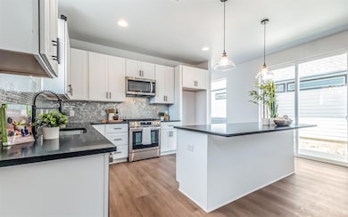 Kitchen featuring tasteful backsplash, appliances