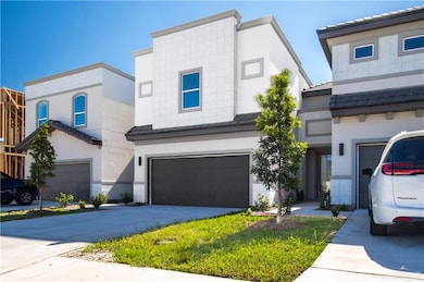 View of front of home with driveway, a tile roof, a garage, and stucco siding