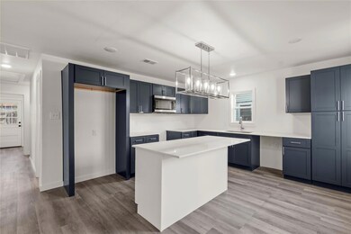Kitchen featuring pendant lighting, sink, a center