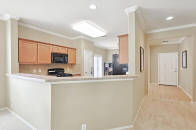 Kitchen featuring crown molding, black appliances,