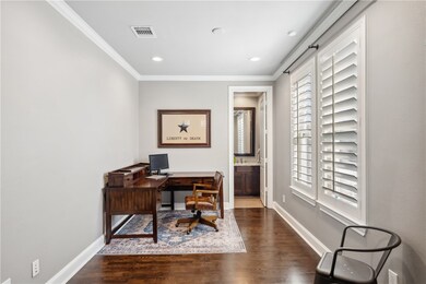 Home office with ornamental molding, wood finished