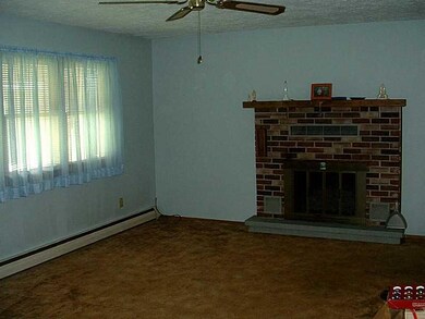 Living Room. Brick Fireplace with Heating Duct Ven