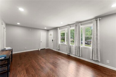Foyer entrance featuring dark wood-type flooring, recessed lighting, and baseboards