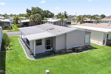 The back of the home features a private, landscaped yard, screened lanai, and a convenient storage shed—ideal for relaxing or enjoying outdoor living.