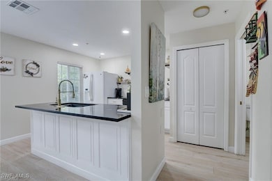 Kitchen with white cabinets, white refrigerator wi