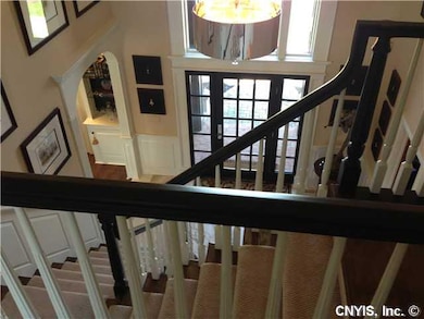 Foyer. Detailed moldings and rich black trim make 