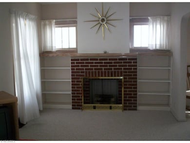 You'll love the large living room with decorative fireplace and built-in shelves.