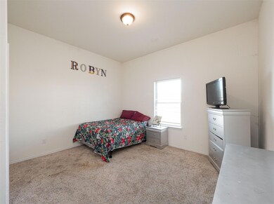 Bedroom with light colored carpet