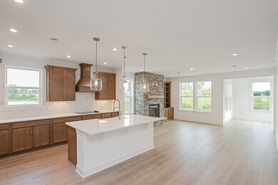 Open plan featuring kitchen, great room, and morning room