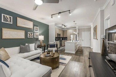 Living room featuring ceiling fan, crown molding, 