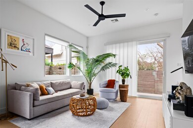 Living area with a ceiling fan, plenty of natural