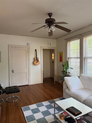 Living room with dark wood-style flooring and a c