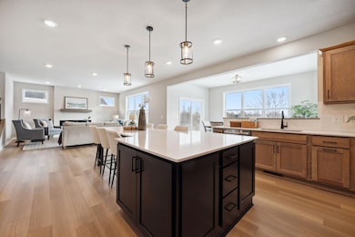 Soak in the sunshine in this bright, open-concept space where the kitchen flows seamlessly into the living and dining areas.