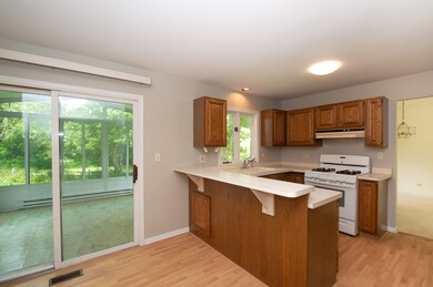 Sunroom right off the kitchen looks over the yard 