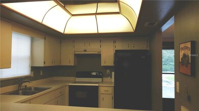 U-shaped kitchen with cupboards galore & a counter