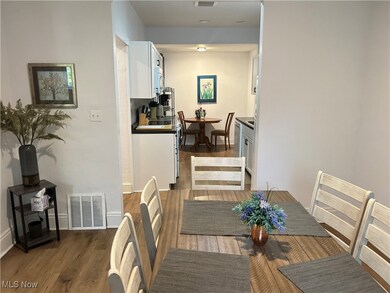 Dining room with dark hardwood / wood-style flooring