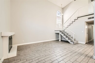 Unfurnished living room with visible vents, wood f