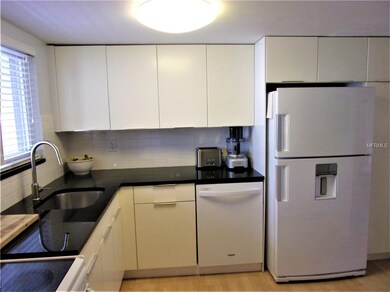 the lazy Susan cabinet to the left of the dishwash