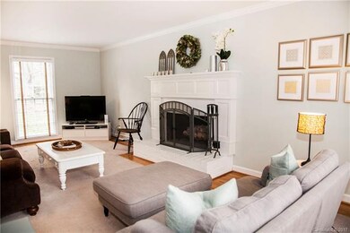 Light and bright living room with masonry fireplac