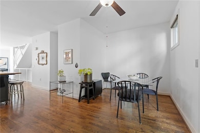 Dining space with a ceiling fan and wood finished floors