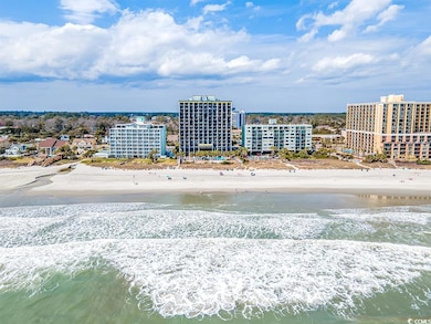 Aerial view featuring a view of the beach and a wa