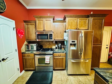 Kitchen with ornamental molding, stainless steel a