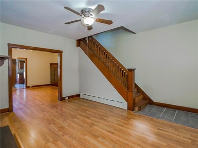 Living room with view into dining room and kitchen