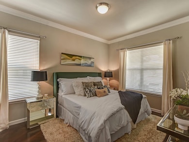 Cozy bedroom with two windows with blinds to allow