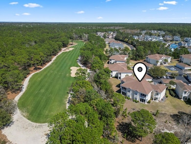 Aerial view with view of golf course, a wooded vie