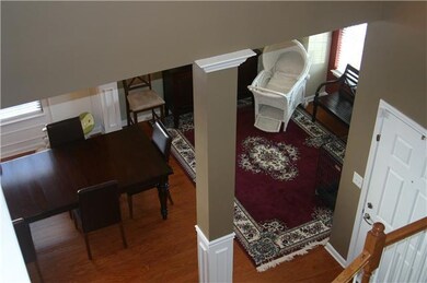 Large two story foyer with formal living room to right of entry door, half bath straight ahead, and stairs to the left heading upstairs to bedrooms and bonus room.