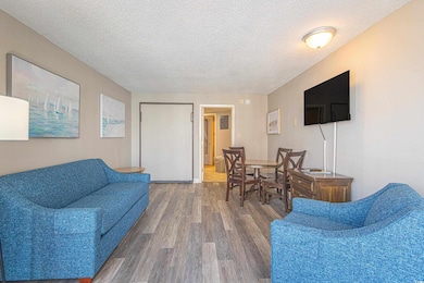 Living room with wood finished floors and a textur