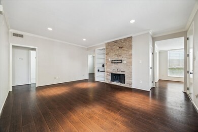 Downstairs living room has brick fireplace and bui