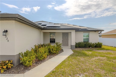 Entrance to property with stucco siding, solar pan