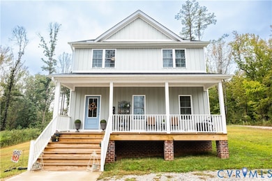 View of front of property featuring board and batten siding, covered porch