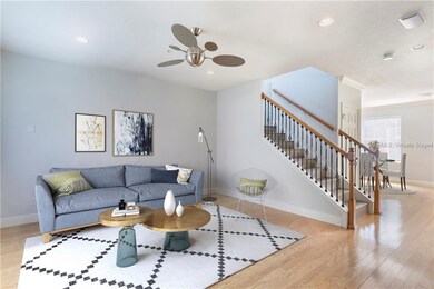 Virtually staged 15 x 14 family room with hardwood floors is open to the kitchen.