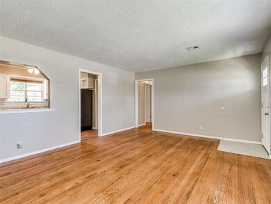 Empty room featuring a textured ceiling and light wood finished floors
