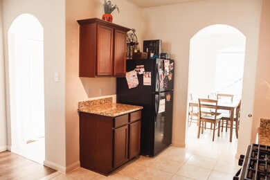 Kitchen featuring light stone counters, light tile